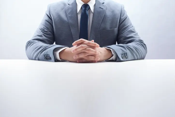 Stephen C. Carter, PC Attorney at Law | Hartwell, GA | businessman sitting at desk with hands folded